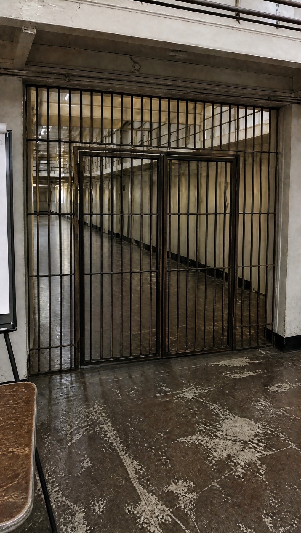 Approved view of a locked institutional gate leading into the cell block
